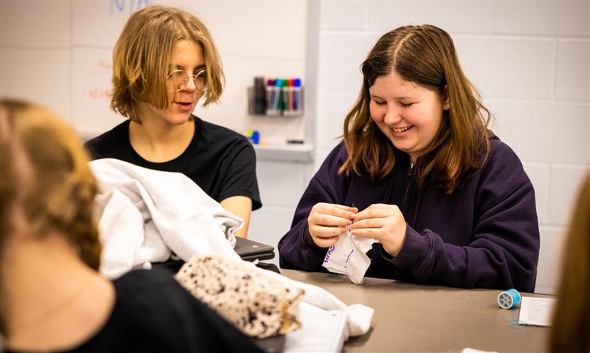 Students practice sewing